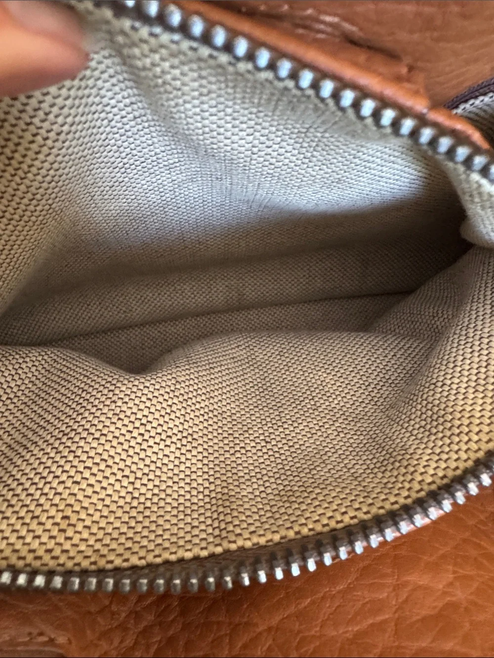 Dooney & Bourke tan pebbled leather side pockets belted satchel bag.
